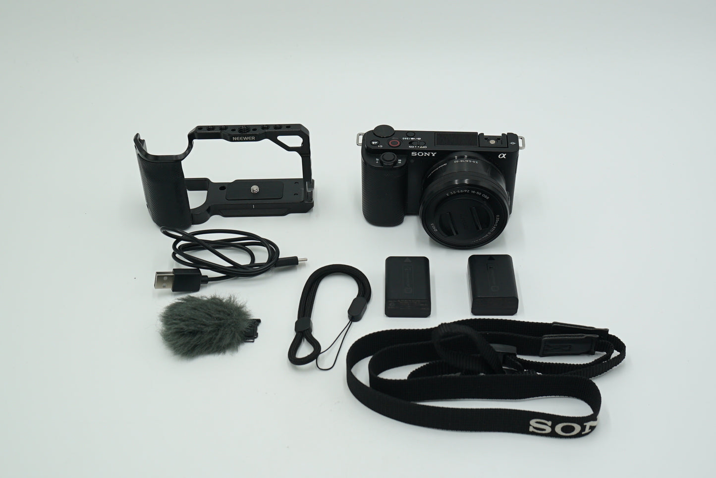 Sony ZVE10L/B/6231368 Mirrorless Camera W/16-50mm Lens + Neewer Cage, Black, Used