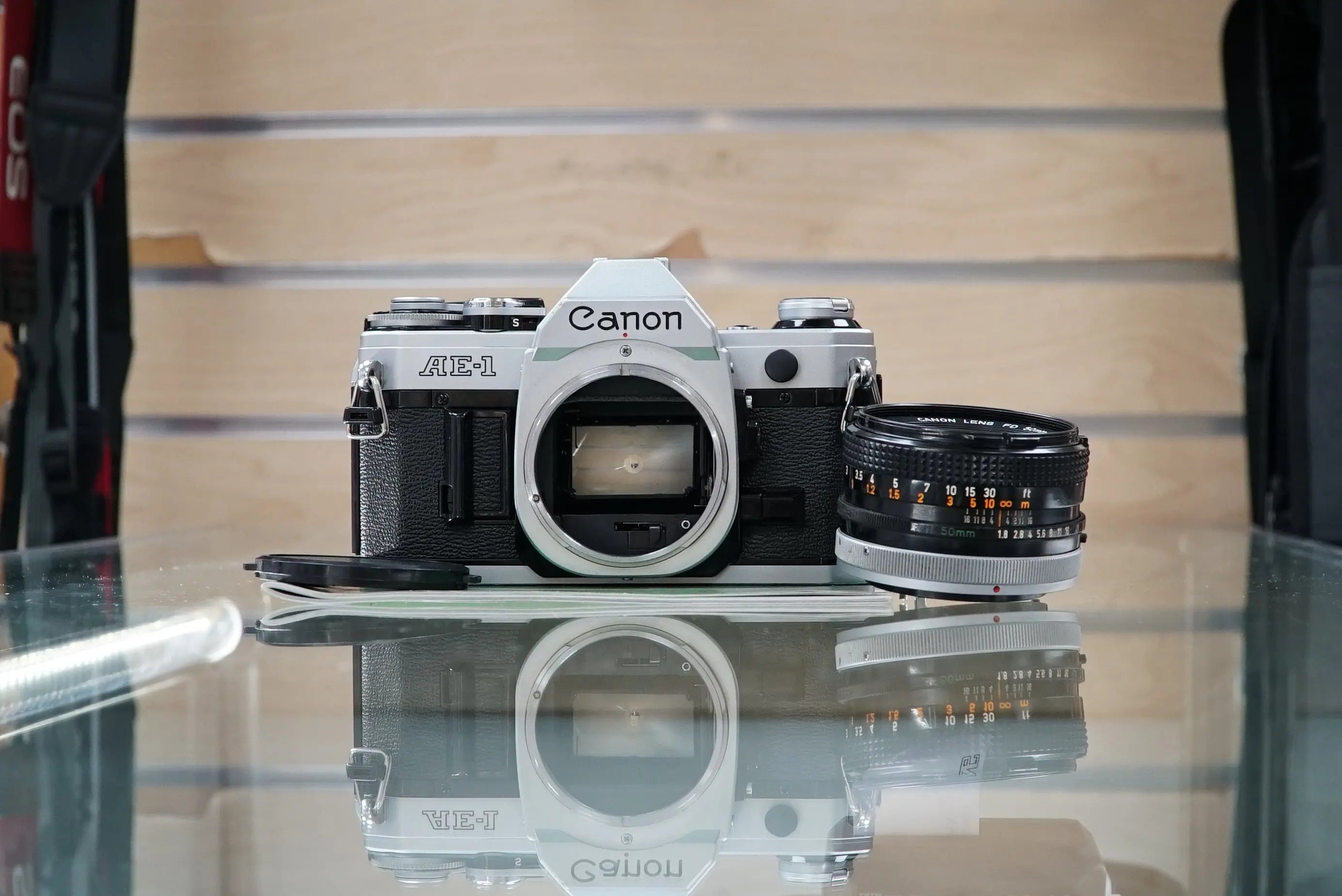 Canon (67090) AE-1 35mm Film SLR Camera w/FD 50mm f1.8 S.C. Lens, Used (Renewed)