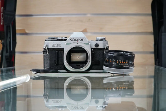 Canon (67090) AE-1 35mm Film SLR Camera w/FD 50mm f1.8 S.C. Lens, Used (Renewed)