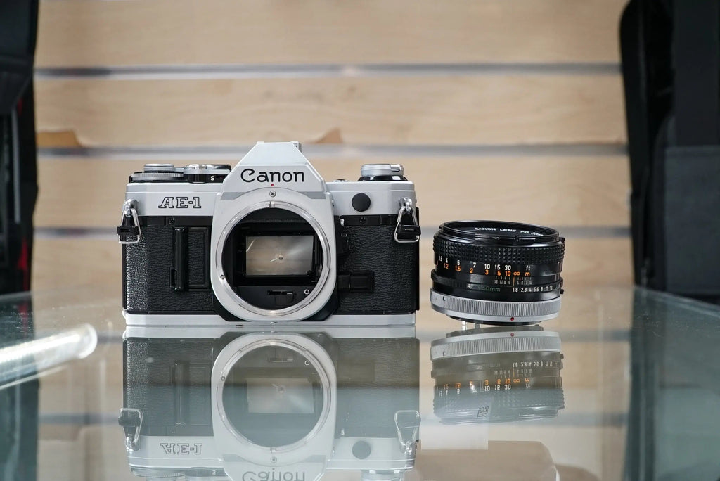 Canon (67090) AE-1 35mm Film SLR Camera w/FD 50mm f1.8 S.C. Lens, Used (Renewed)