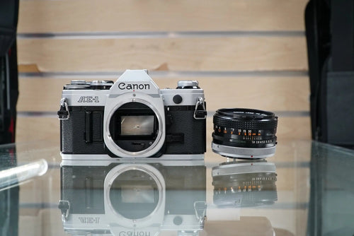 Canon (67090) AE-1 35mm Film SLR Camera w/FD 50mm f1.8 S.C. Lens, Used (Renewed)