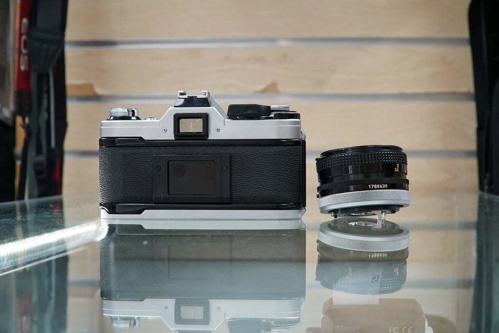 Canon (67090) AE-1 35mm Film SLR Camera w/FD 50mm f1.8 S.C. Lens, Used (Renewed)