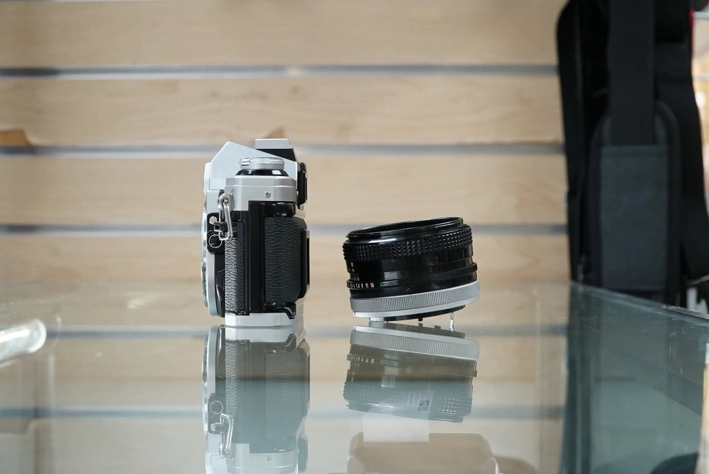 Canon (67090) AE-1 35mm Film SLR Camera w/FD 50mm f1.8 S.C. Lens, Used (Renewed)