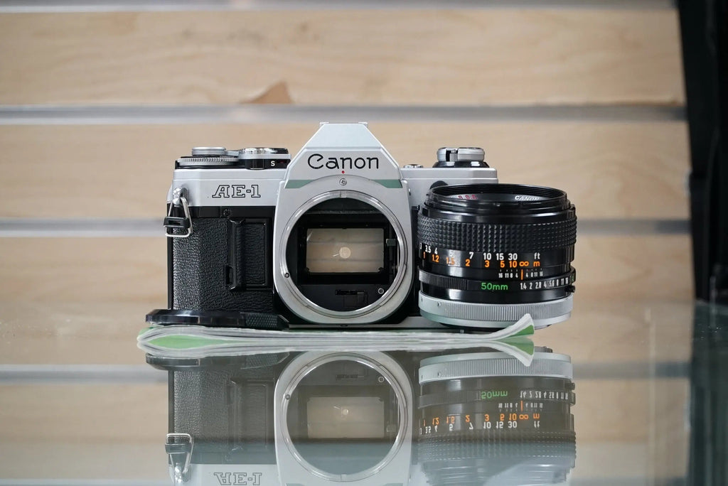 Canon (30280) AE-1 35mm Film SLR Camera w/FD 50mm f1.4 S.S.C. Lens, Silver, Used (Renewed)