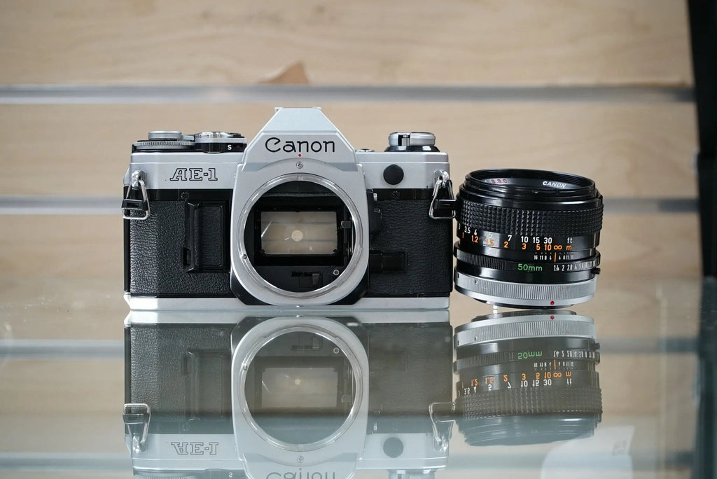 Canon (30280) AE-1 35mm Film SLR Camera w/FD 50mm f1.4 S.S.C. Lens, Silver, Used (Renewed)