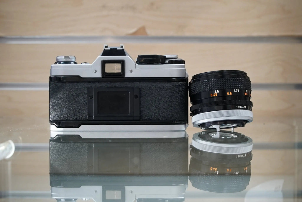 Canon (30280) AE-1 35mm Film SLR Camera w/FD 50mm f1.4 S.S.C. Lens, Silver, Used (Renewed)