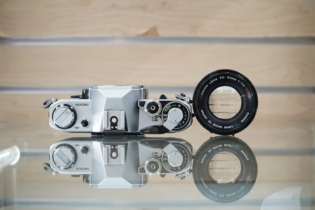Canon (30280) AE-1 35mm Film SLR Camera w/FD 50mm f1.4 S.S.C. Lens, Silver, Used (Renewed)